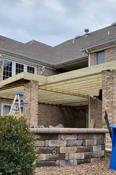 residential property exteriors with pergola installation in process evansville in